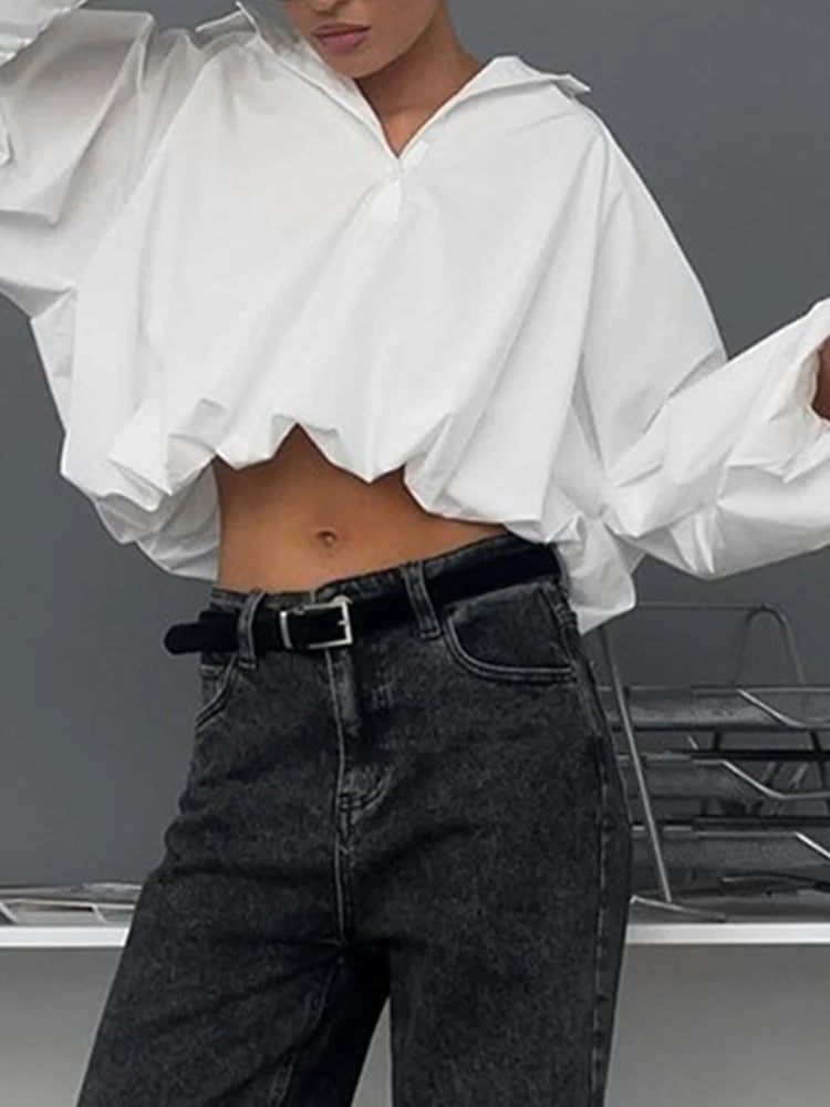 Blusa blanca elegante con volantes y manga larga