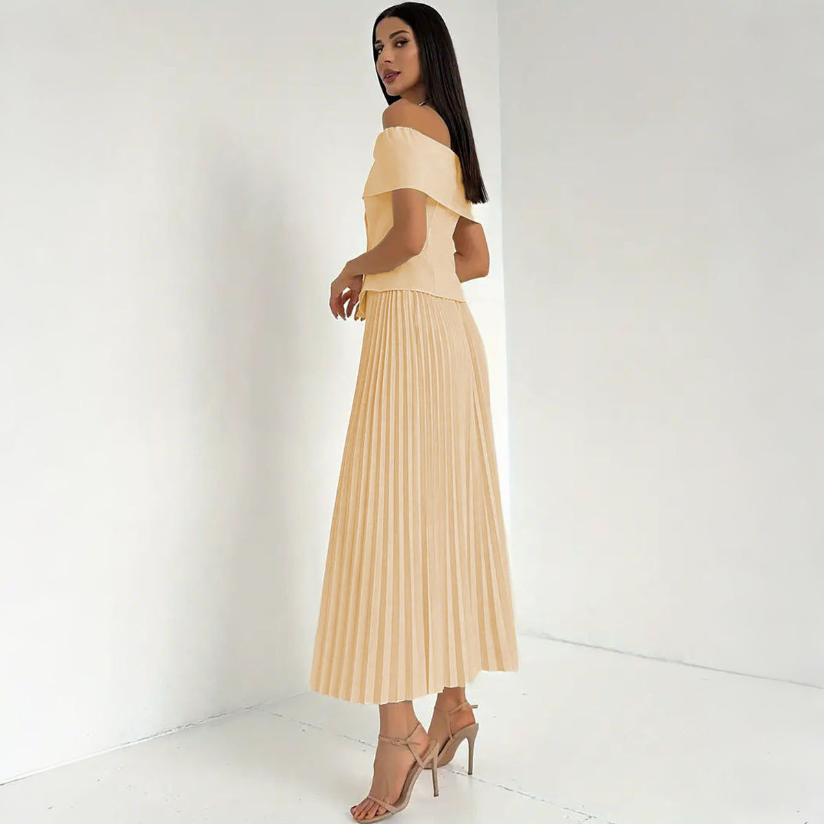 Conjunto elegante con top de hombros descubiertos y falda plisada