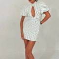 Vestido de lunares con cuello alto y detalles calados