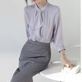 Blusa morada de manga larga con lazo
