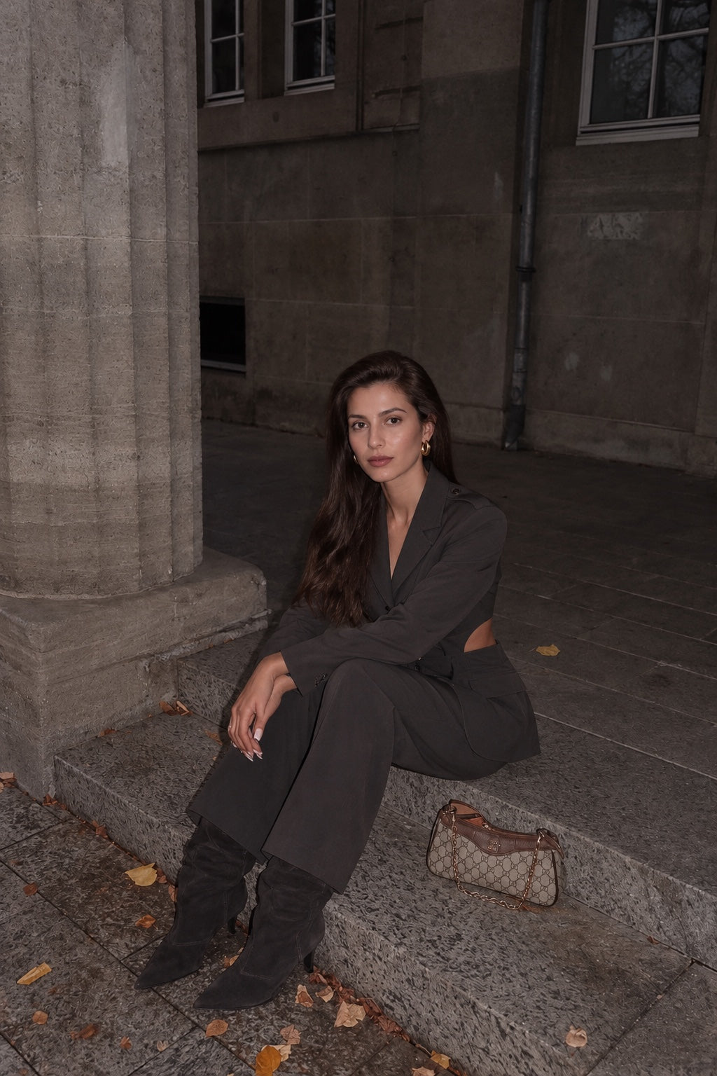 Modelo sentada con conjunto de blazer y pantalón